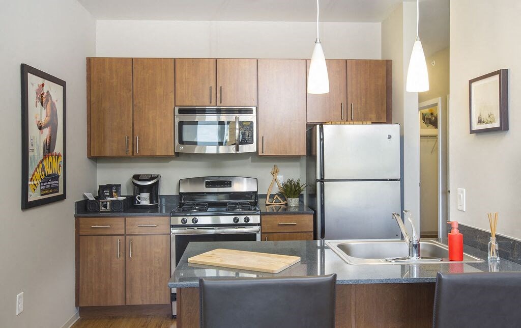 a kitchen with wooden cabinets and stainless steel appliances