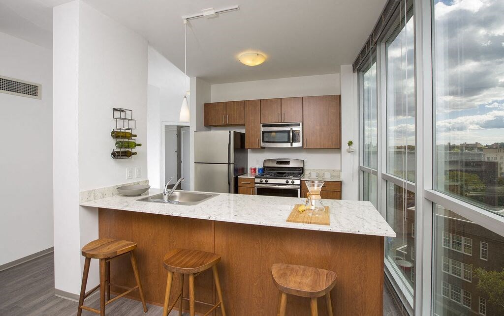 a kitchen with a counter top next to a window