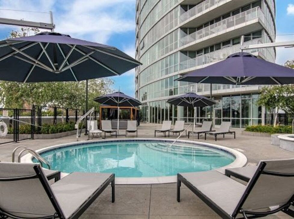 a swimming pool next to a tall building