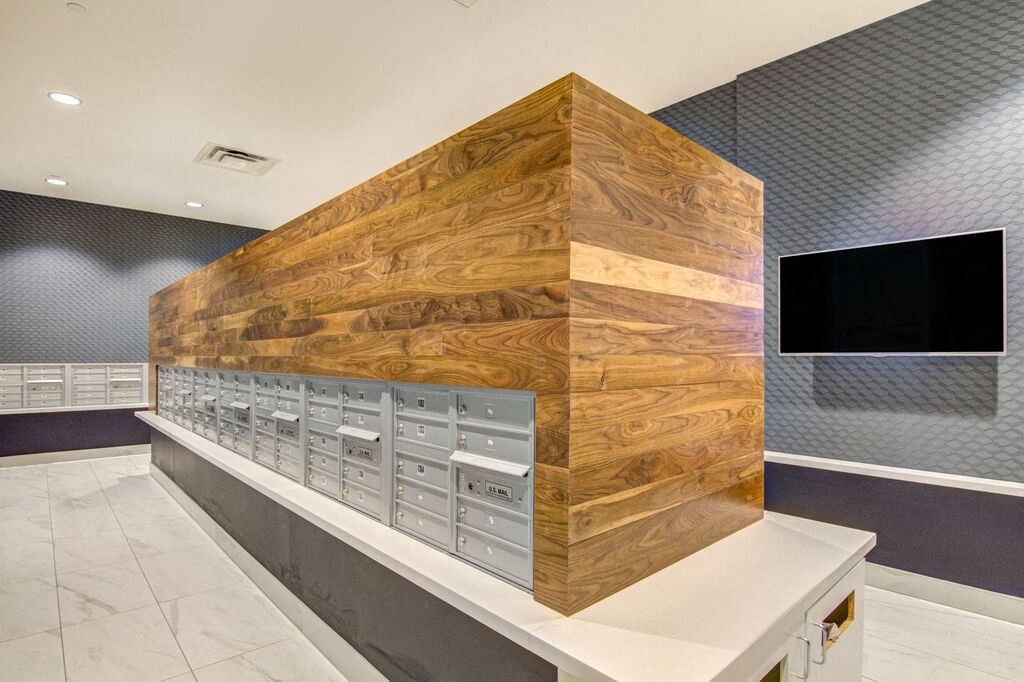 a view of the mailroom with a large wooden wall and a large tv on the wall