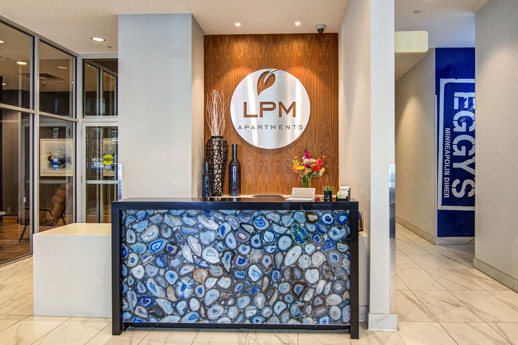 a reception desk with a lpm logo on it