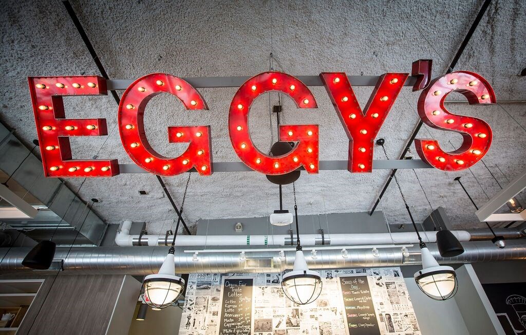 a large red sign with lights hanging from the ceiling