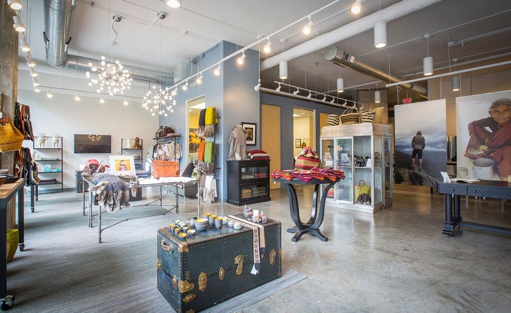 a room filled with lots of furniture and a large painting on the wall