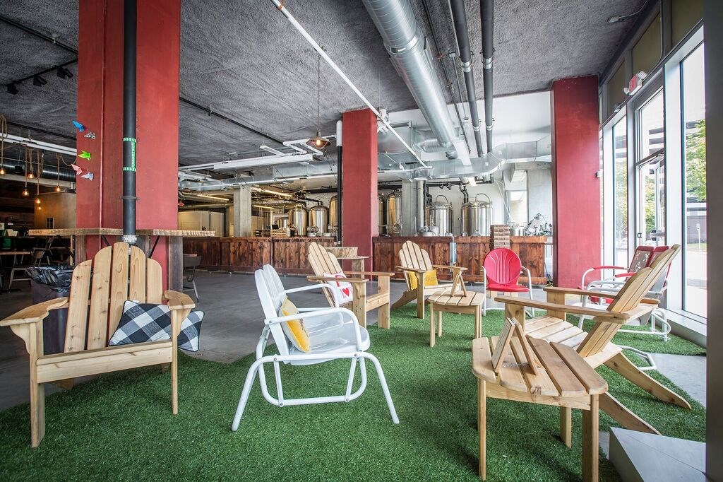 a large open room with green astroturf and chairs