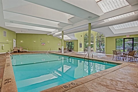 A large indoor swimming pool with a glass ceiling.