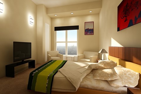 A bedroom with a large bed and a television.