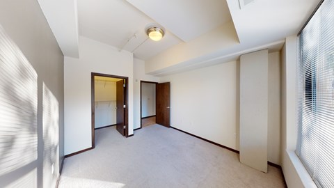 A room with white walls and a carpeted floor.