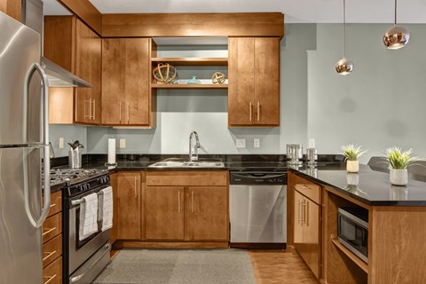 A modern kitchen with wooden cabinets and stainless steel appliances.