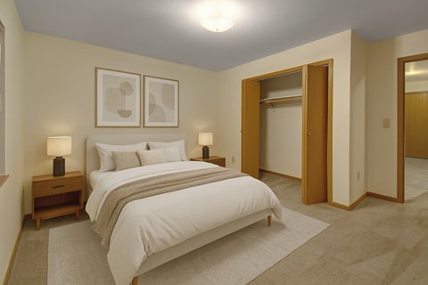 A bedroom with a large bed and two lamps.