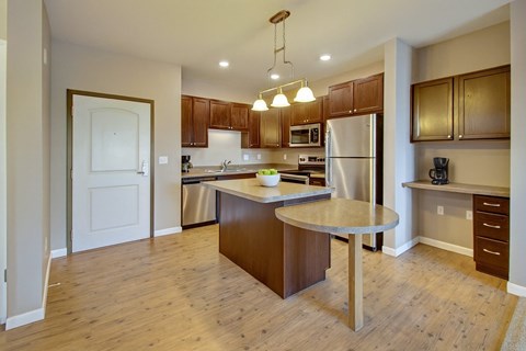 A kitchen with a large island in the middle.