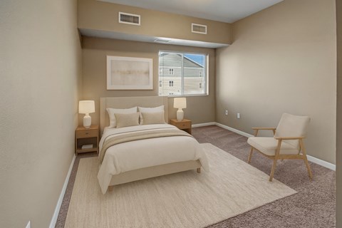 A bedroom with a large bed and a chair.