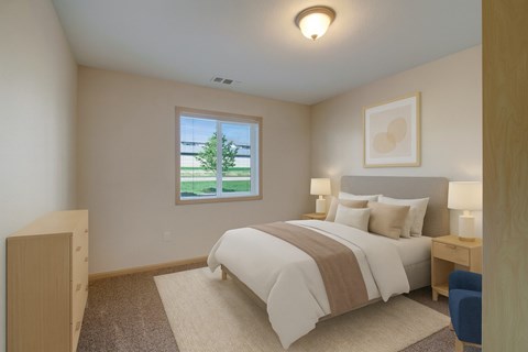 A bedroom with a large bed and a window overlooking a green tree.