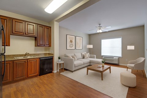 A modern kitchen with wooden cabinets and a white sofa.
