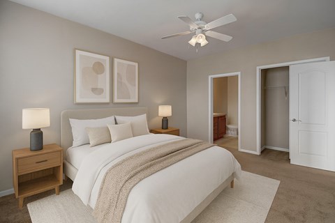 A bedroom with a large bed and two lamps on side tables.