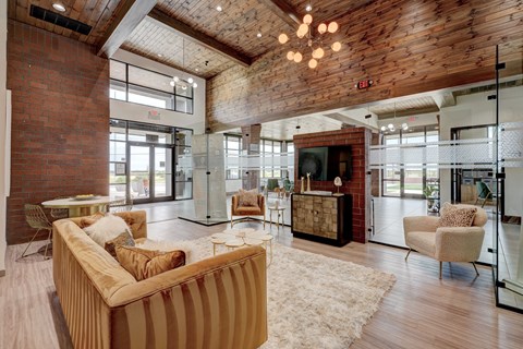 A living room with a striped couch and a wooden ceiling.