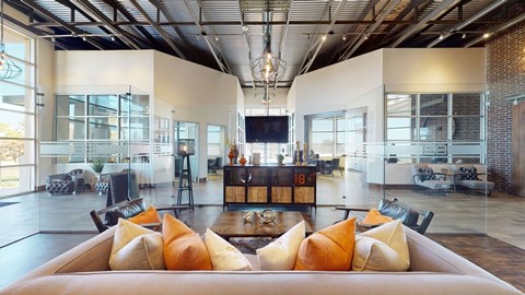 A modern living room with a large couch and a television.