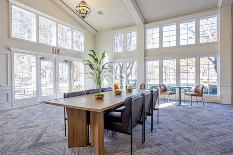 A conference room with a long table and chairs.