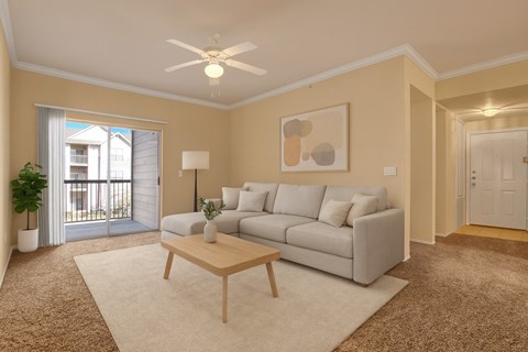 A living room with a grey couch, a wooden coffee table, and a painting on the wall.