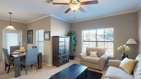 A living room with a dining table and chairs.