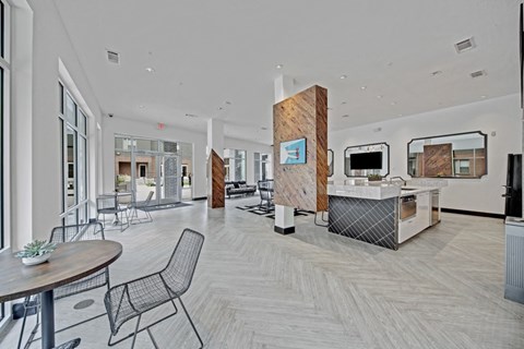A modern office space with a reception desk and chairs.