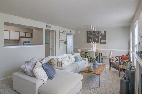 A living room with a white couch and a coffee table.