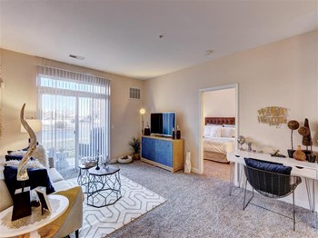 Residence at North Penn living room with natural lighting Residence at North Penn living room with lush carpet - Photo Gallery 3