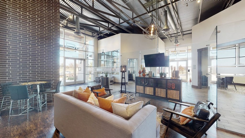 a living room with a couch chairs and a tv