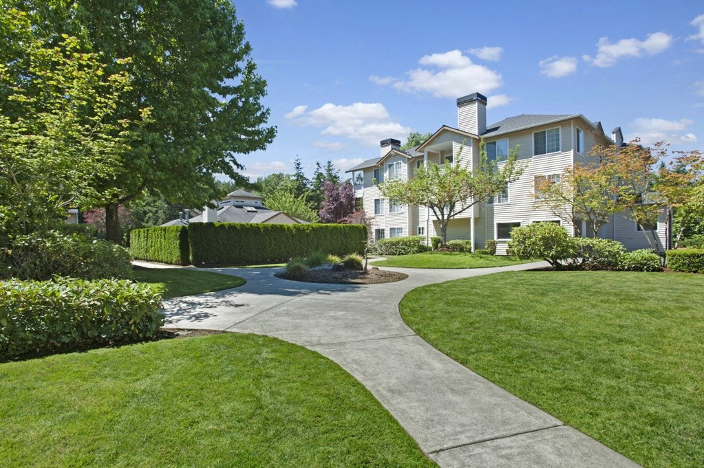 A large house with a curved driveway in front of it.