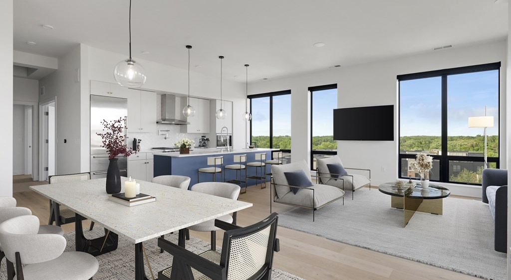 A modern dining room with a large table and chairs.