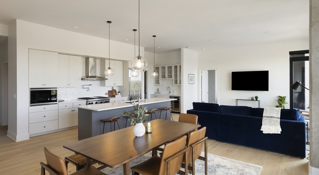 A modern kitchen with a dining table and chairs.