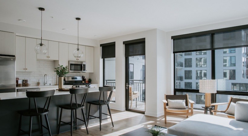 A modern kitchen with a dining table and chairs.
