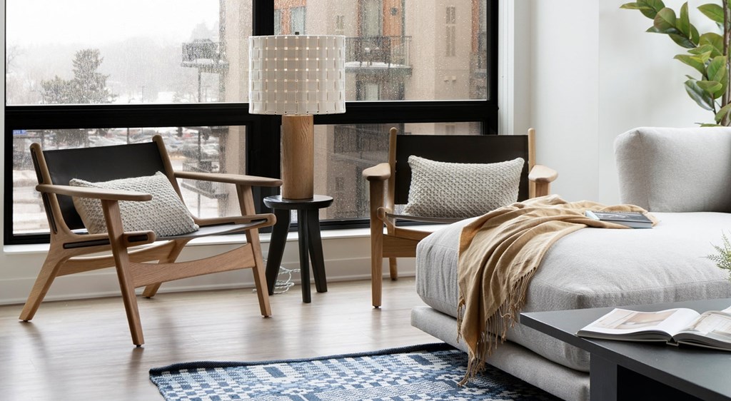 A bedroom with a bed, chair, and table.