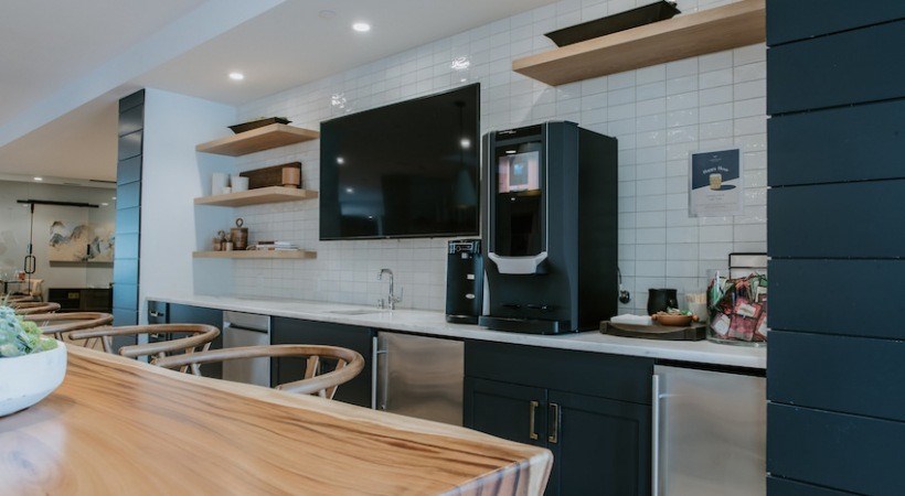 A modern kitchen with a wooden countertop and stainless steel appliances.