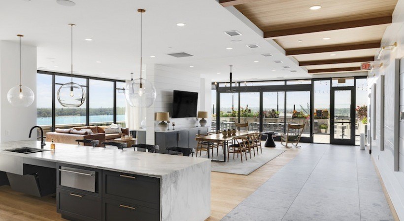 A modern kitchen with a large island and a view of the water.