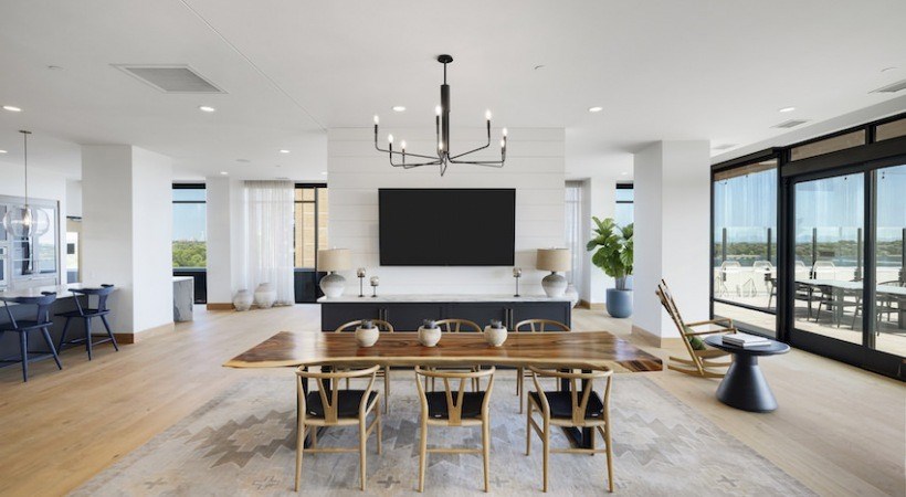 A modern dining room with a wooden table and chairs.