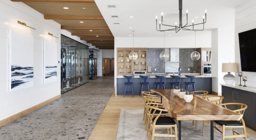 A modern kitchen with a dining table and chairs.