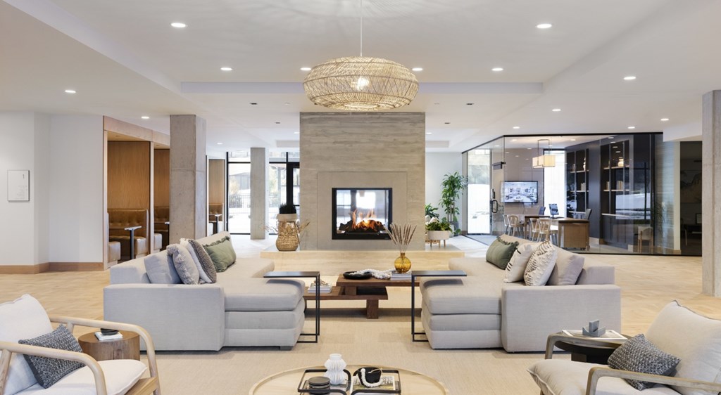 A modern living room with a grey sofa set and a chandelier.