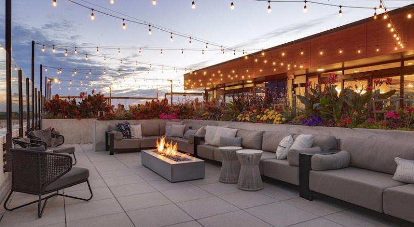 A patio with a fire pit and seating area.