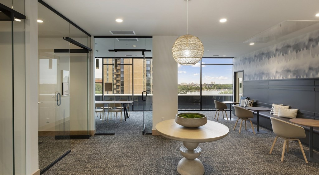 A modern living room with a glass door leading to a balcony.