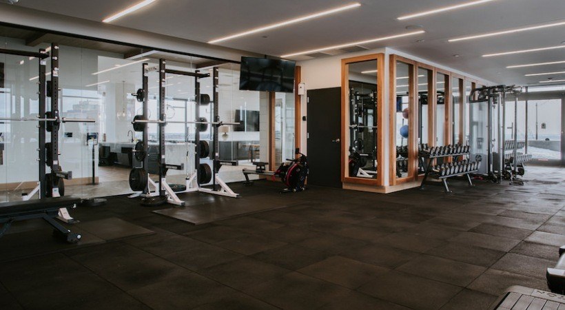A gym with a variety of equipment including weights and machines.
