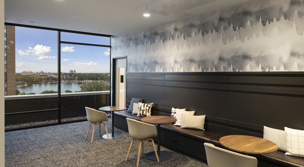 A modern dining room with a view of the city.