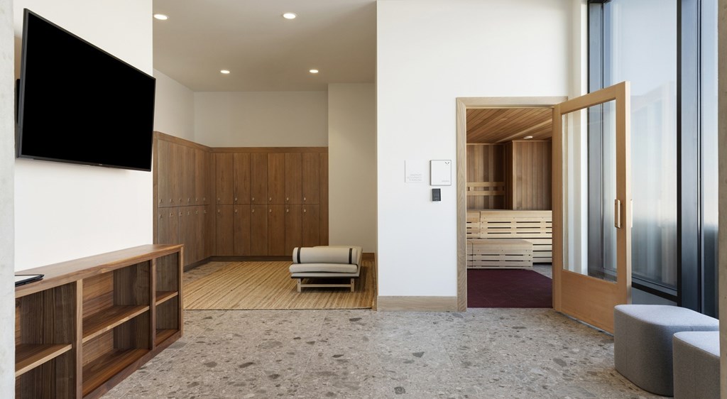 A modern living room with a flat screen TV mounted on the wall.