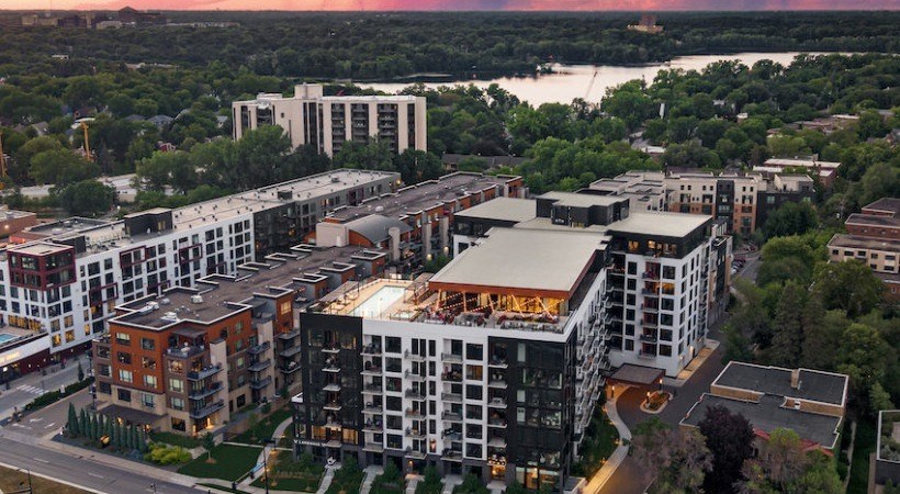 A large building complex with a parking lot in front.