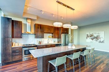 a kitchen with wood cabinets and a granite countertop