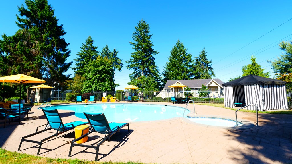 A pool area with blue chairs and a yellow umbrella.