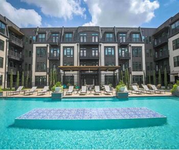 Resort pool with cabanas and loungers