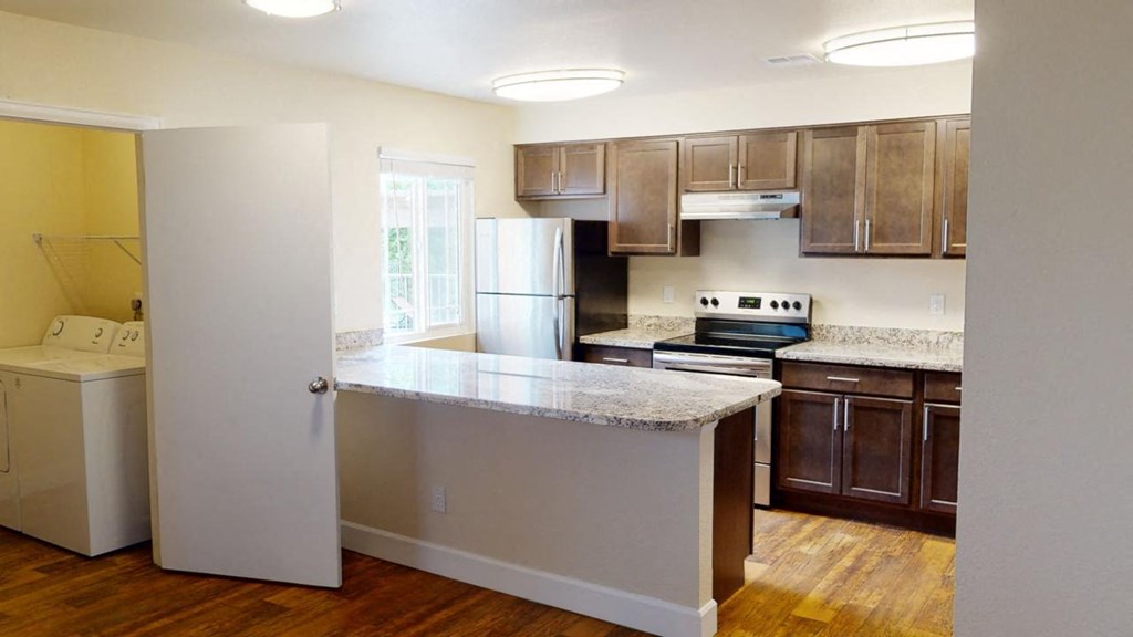 a kitchen with a counter top and a refrigerator