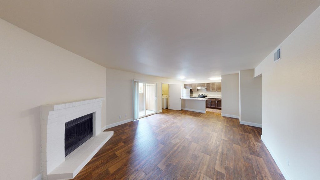 a living room with a fireplace and a hard wood floor