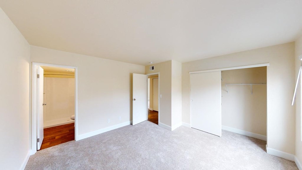 a bedroom with a carpeted floor and white walls