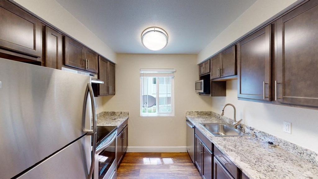 a kitchen with stainless steel appliances and granite counter tops